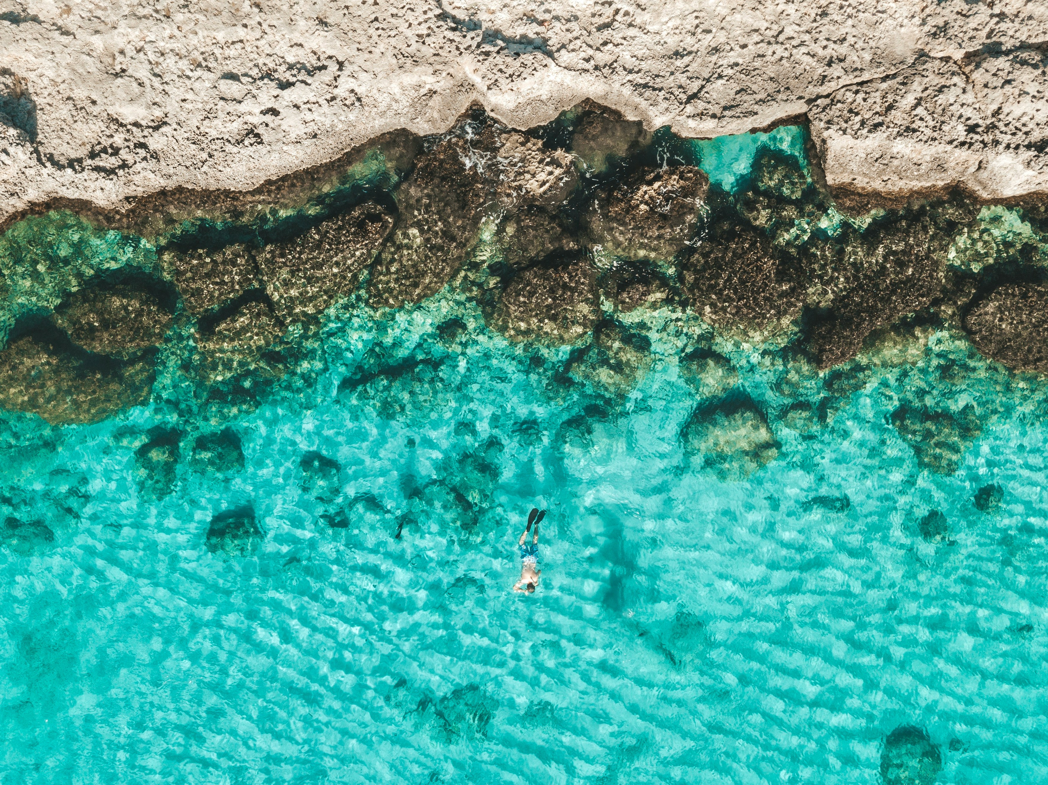 Aerial view of turquoise Aruban waters at golden hour